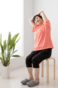 Decorative Image: Lady doing chair yoga
