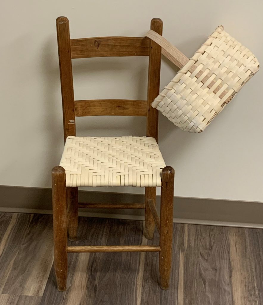 Old child's chair with rewoven seat and handwoven basket