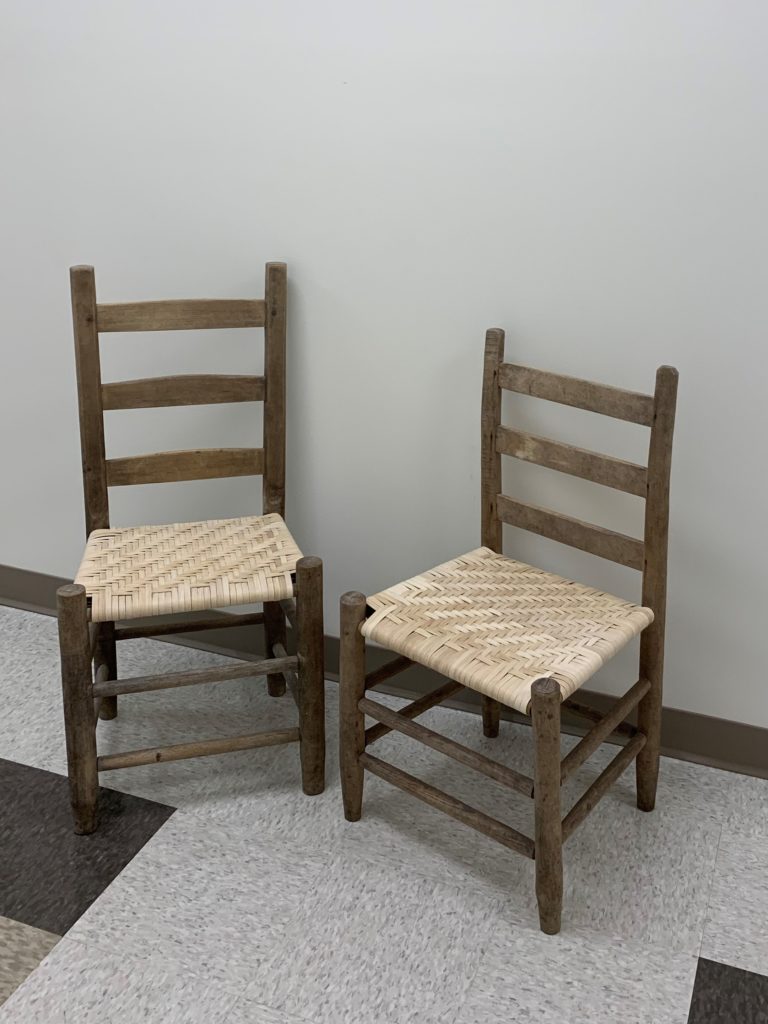 Two handmade chairs with newly handwoven seats.