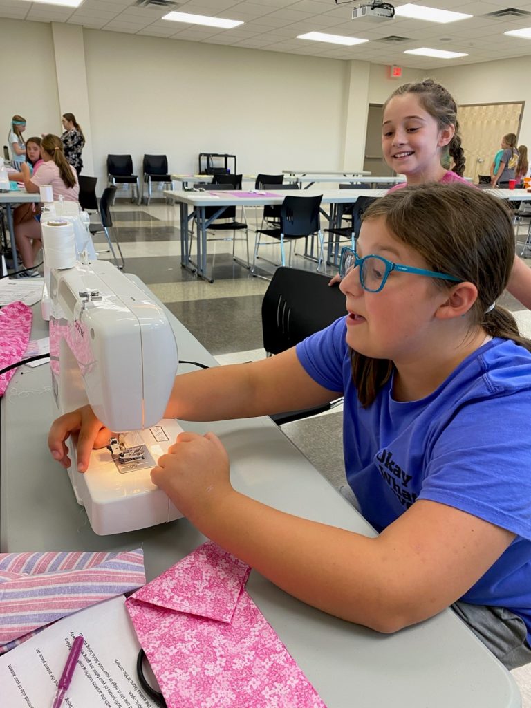 Two girls sewing