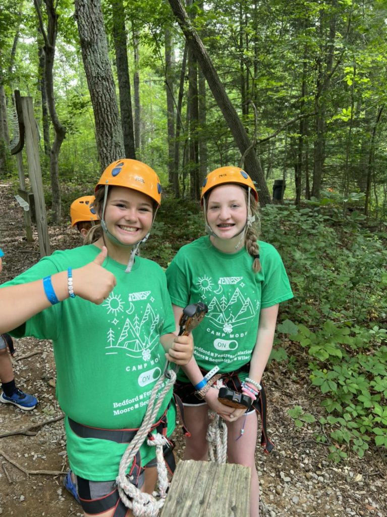 Students in green 4-H T-shirts on a hike