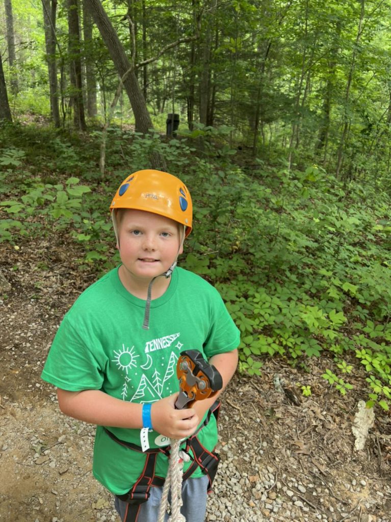 Student in green 4-H T-shirt on a hike