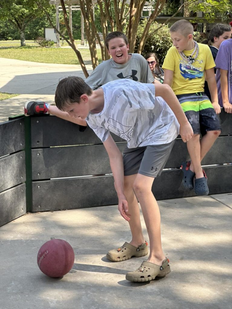Child playing with a ball at 4-H Camp